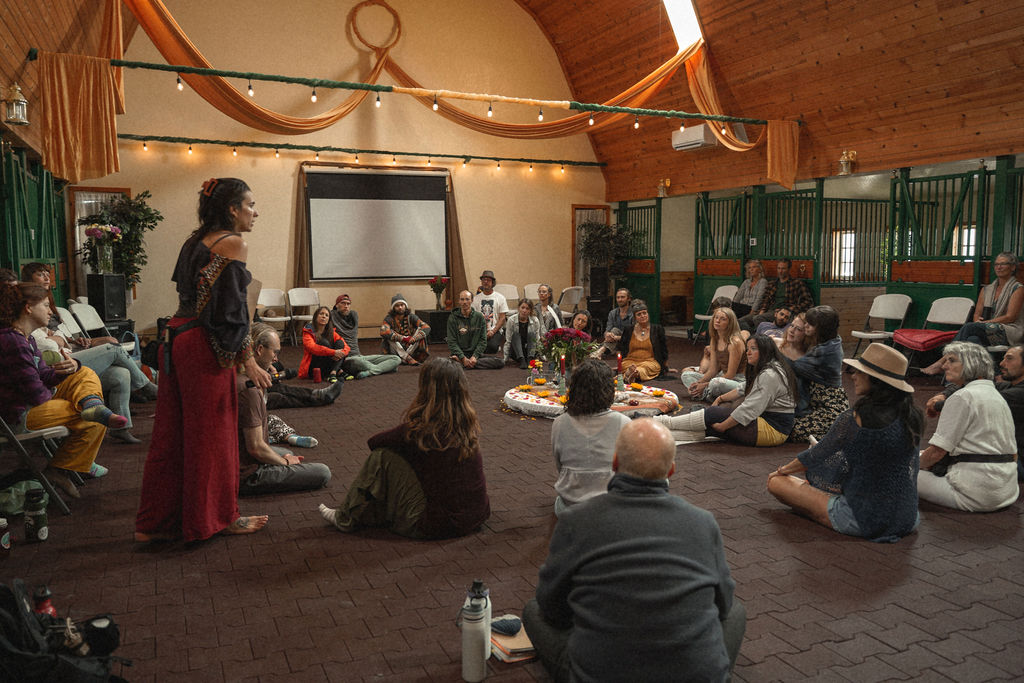 A community council gathered in a large circle inside a great hall.